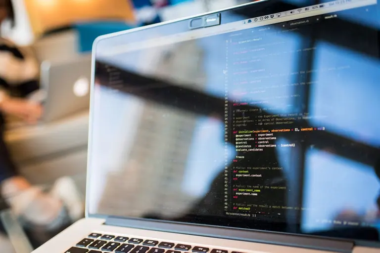 Laptop displaying website development code